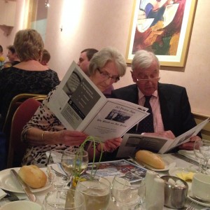Sheila Hogg looking over the booklet with Bill Walker