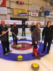 Ann Redpath draws the shot with the last stone of the Closing Bonspiel
